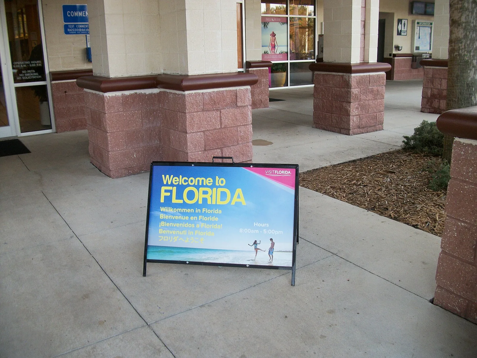 A Welcome to Florida sign in six languages standing outside the visitor building at the southbound I-95 Florida Welcome Center